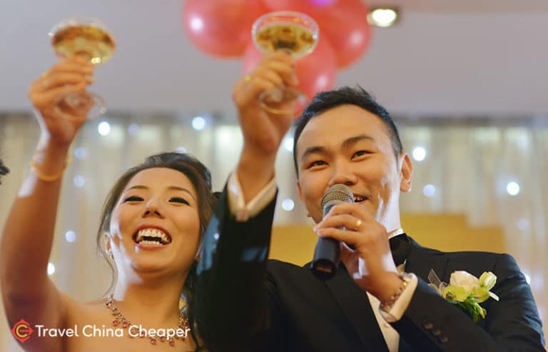 A Chinese bride and groom toasting during their wedding using Chinese alcohol