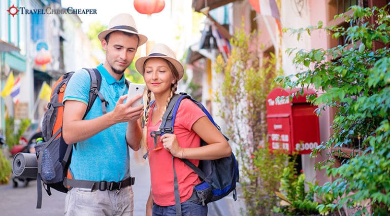 Travelers in China using a mobile phone