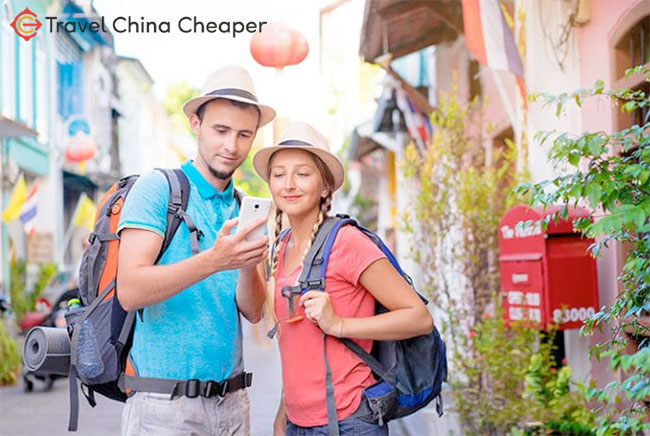 Travelers in China using a mobile phone